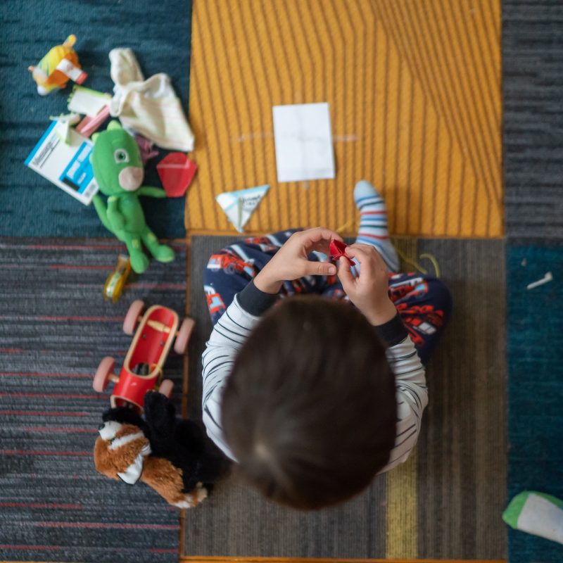 top-view-photography-of-toddler-playing-with-toy-2790771